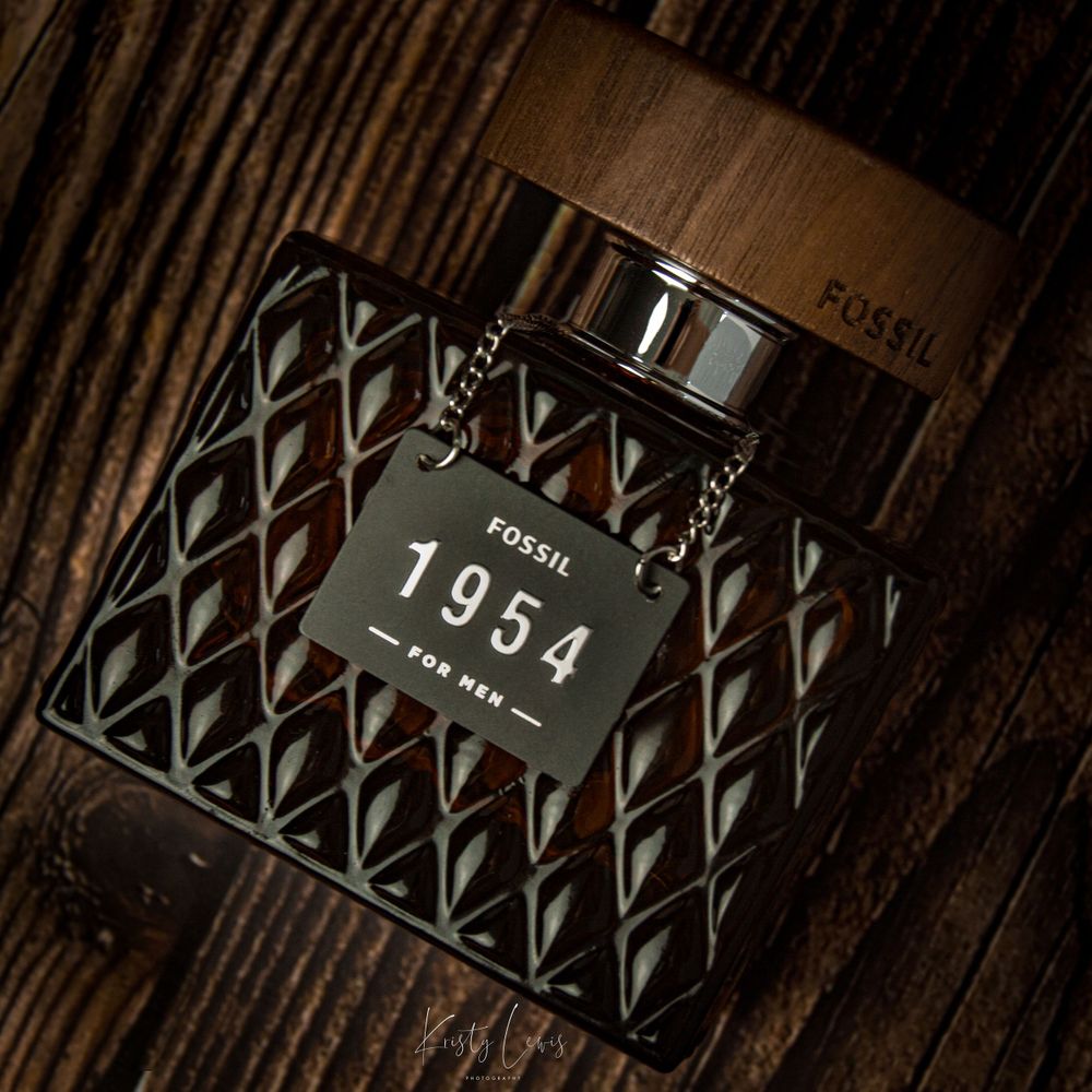 Product photography shot of a brown glass aftershave bottle captured on a brown wood background. Shot in Blackwood, South  Wales