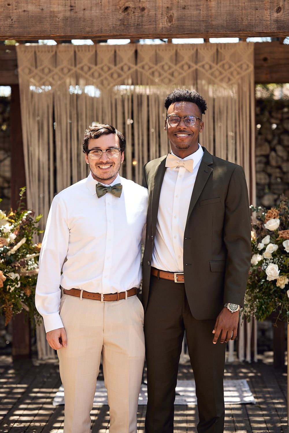 Groom and best man together for a picture in front of the ceremony area at the Riverbed Farm in Anaheim, California.