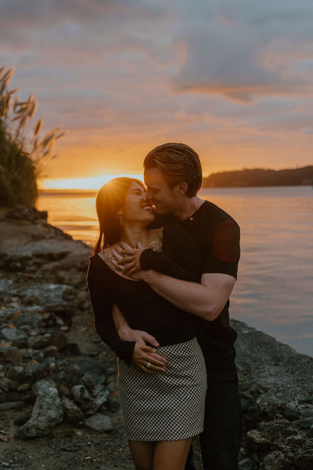 Creative, fun, laidback sunset engagement photos at Sentinel Beach. Howdy Pictures are film wedding photographers in New Zealand