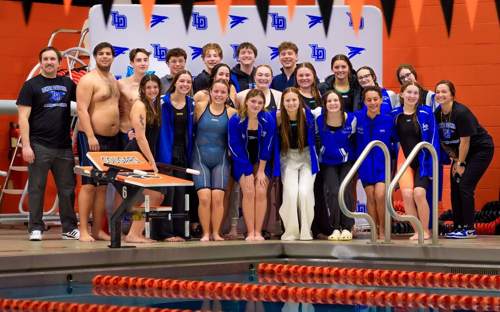 Lower Dauphin High School swimming seniors and teammates pose together on the pool deck during Senior Night celebration.