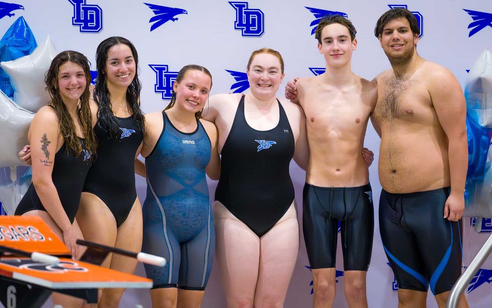 Lower Dauphin High School senior swimmers pose for a group portrait in front of the LD Falcons backdrop on Senior Night.