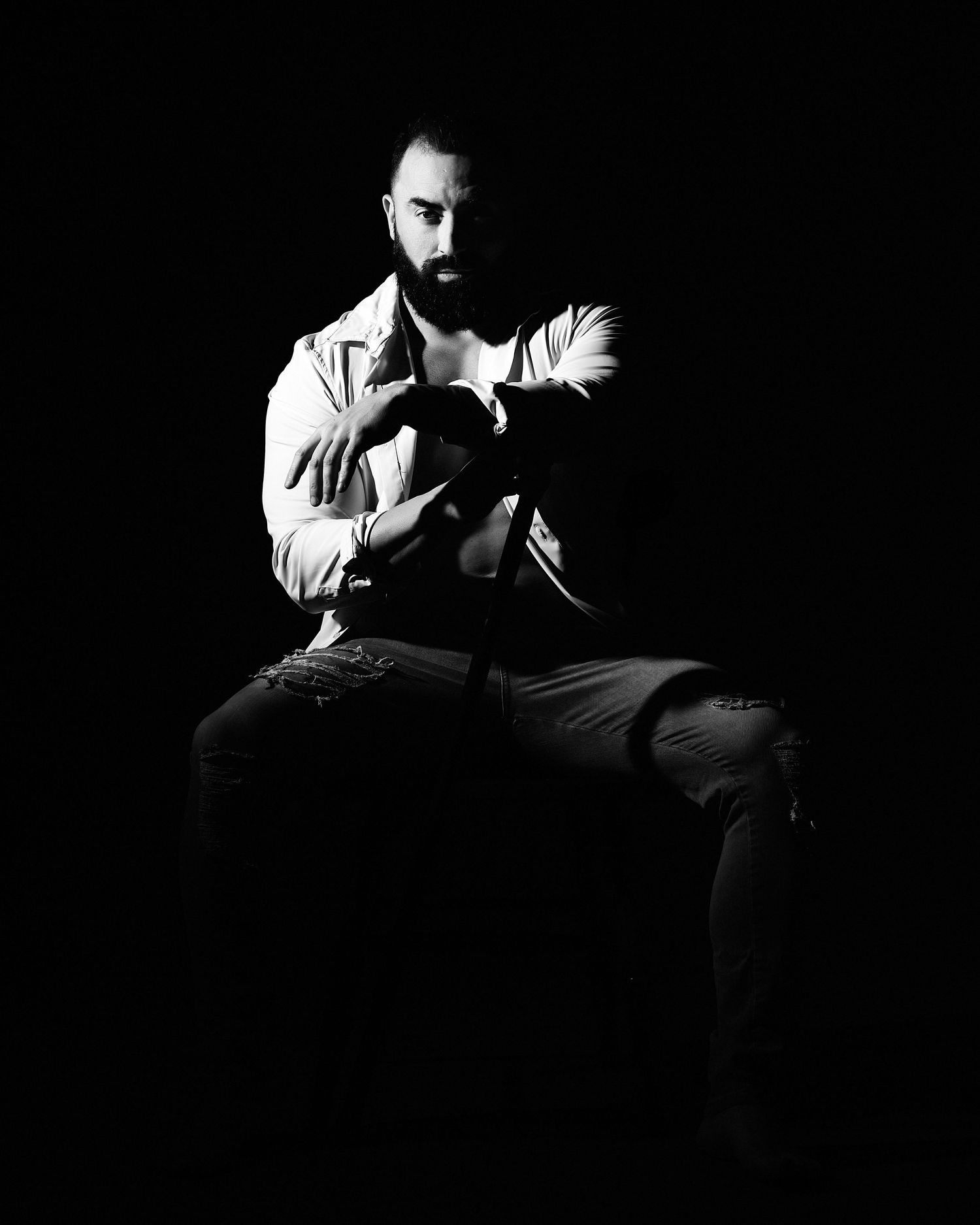 David G Holt Photography - Dramatic noir-style portrait with harsh lighting creating strong shadows and contrast.