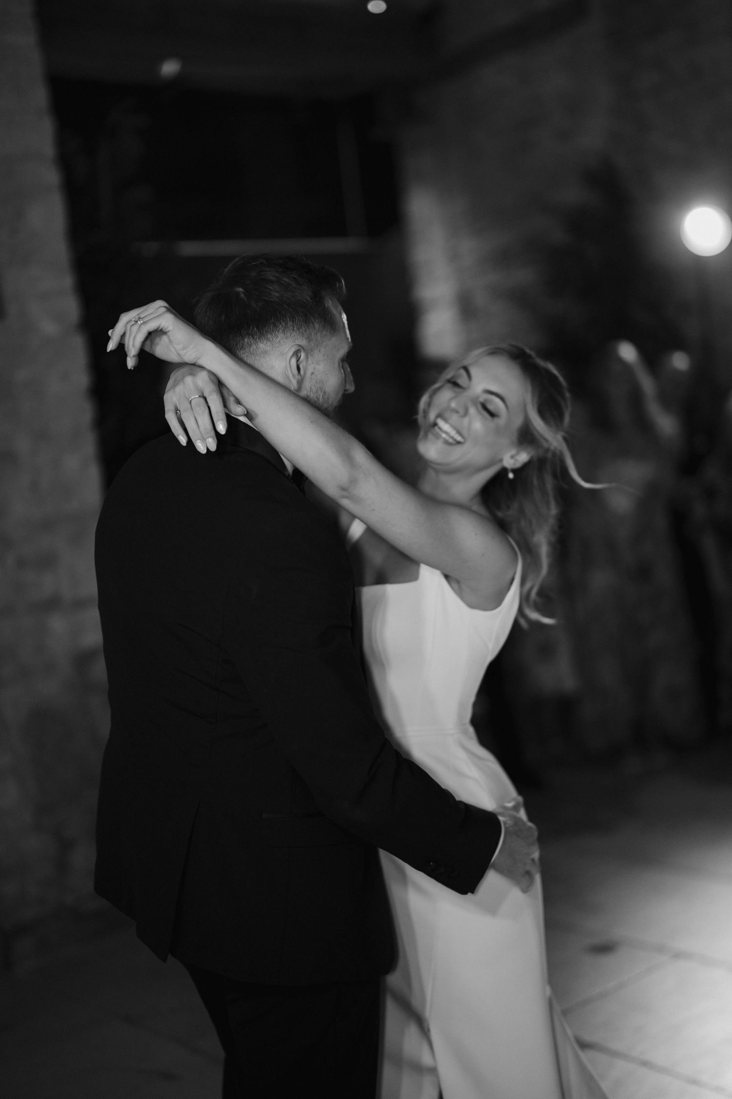 groom lifting bride during first dance as bride laughs at ivy lodge wedding in cirencester