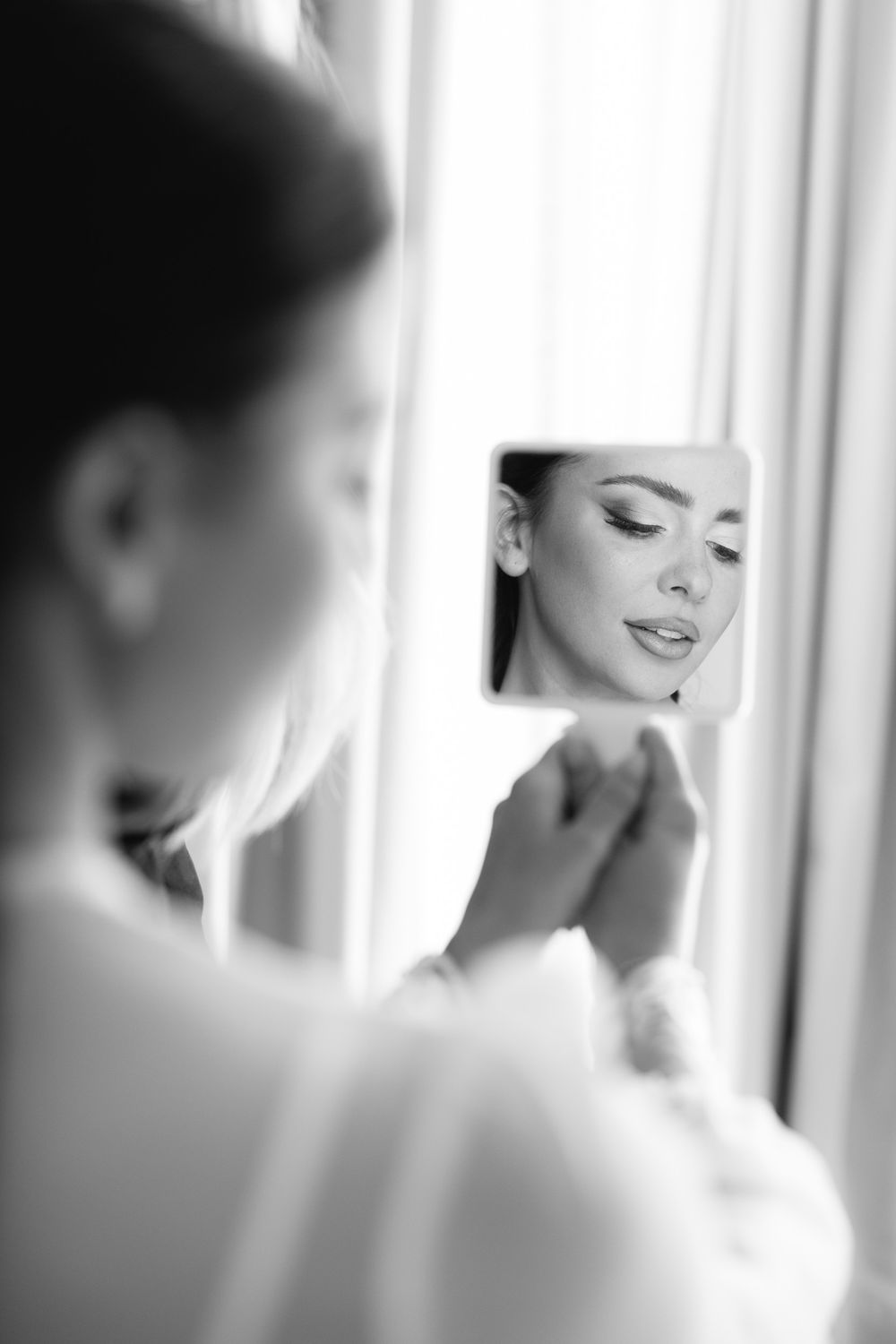 A soft black and white artistic photo series showing blurred close-up portraits with delicate lighting and expressions.
