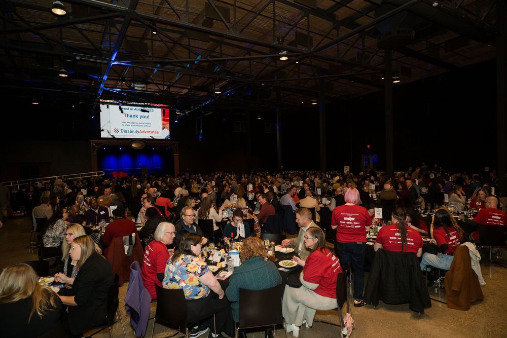 Large crowd gathered in a dimly lit venue for a special event.
