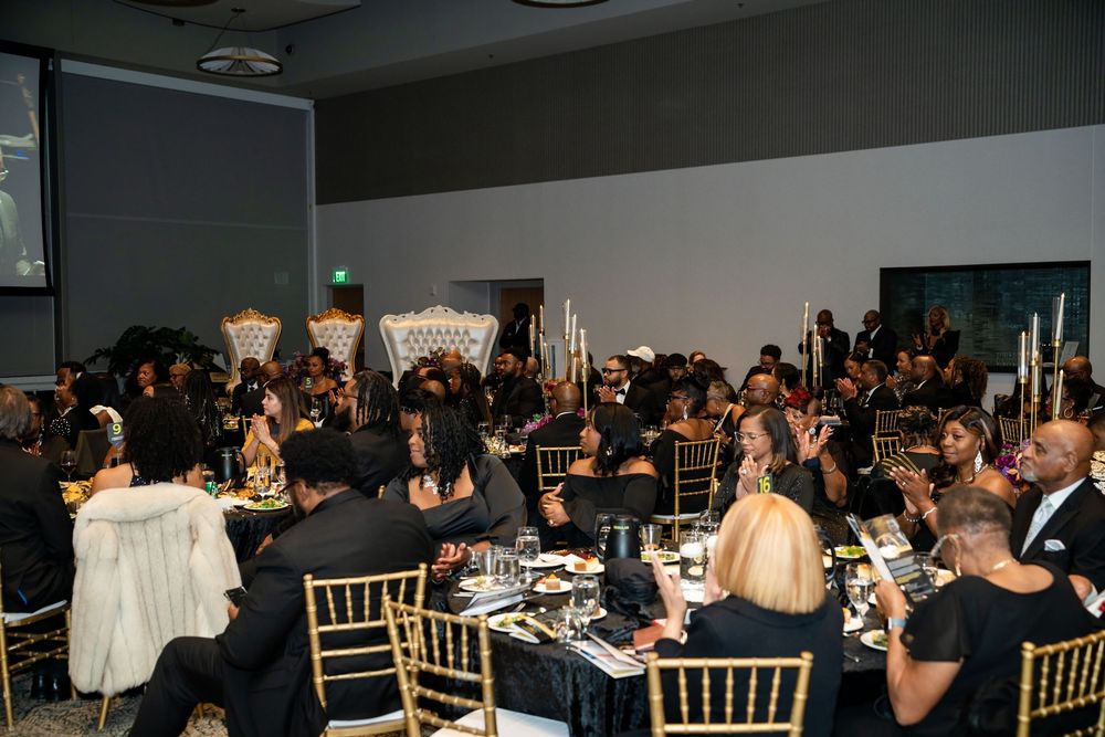 Banquet hall setup with elegant table settings and guests enjoying a formal dinner.
