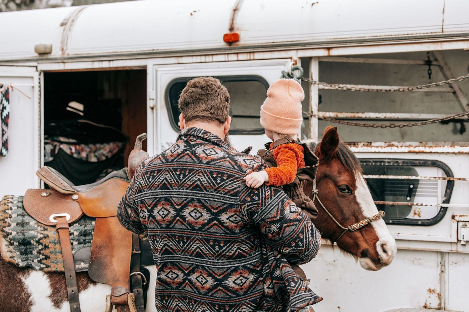 Cle Elum, WA engagement photography. Man holds young daughter with pink beanie on.