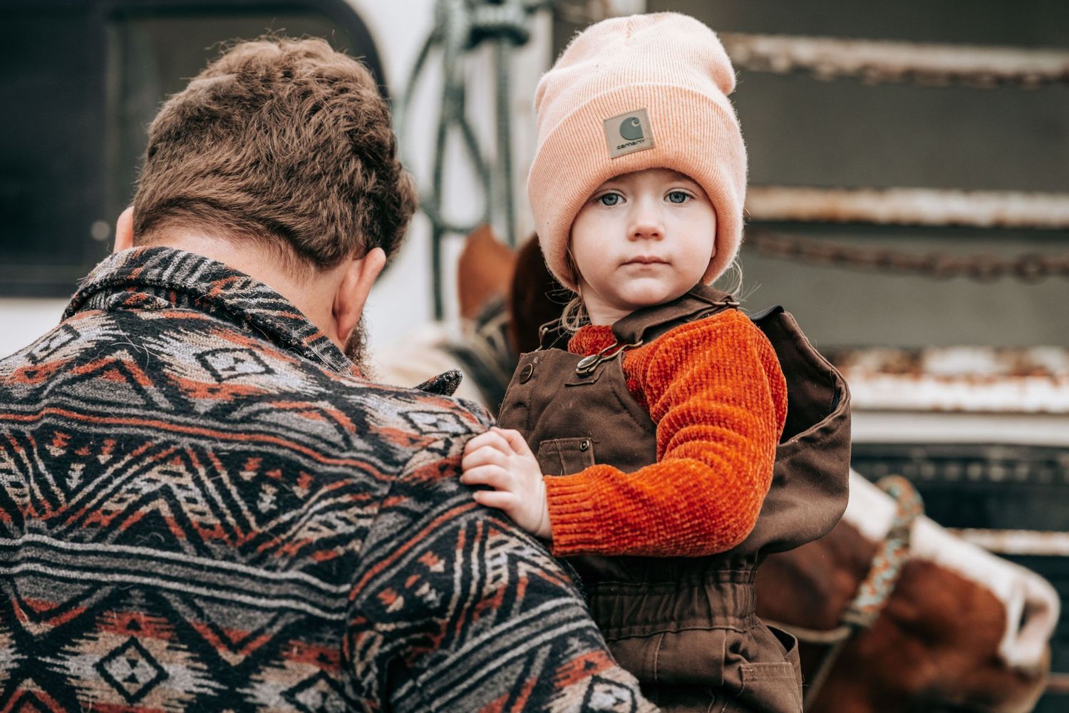 Cle Elum, WA engagement photography. Man holds young daughter with pink beanie on.