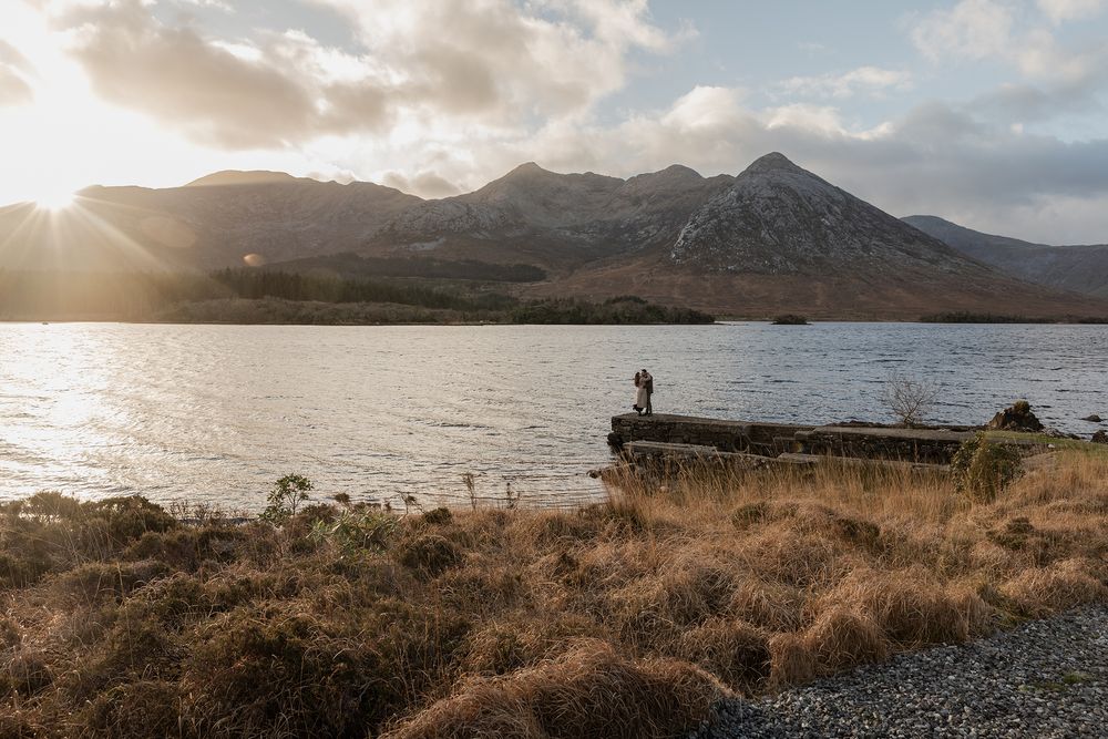 Bride-to-be reacting to surprise proposal at Lough Inagh Valley at sunset