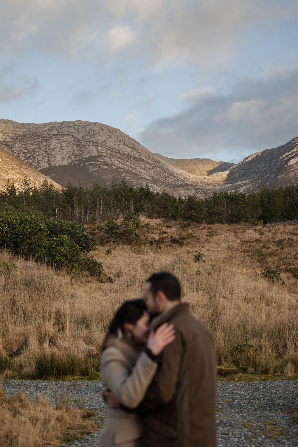 Walking through moody winter woodland during Connemara adventure session