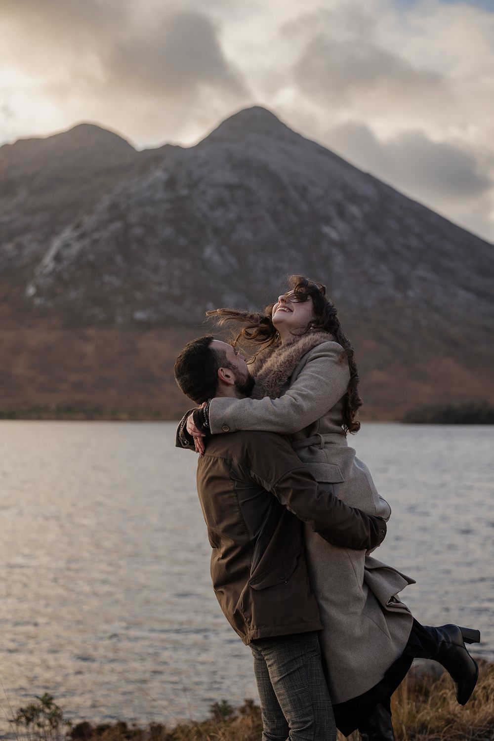Adventure couples session capturing sunset over Connemara landscape