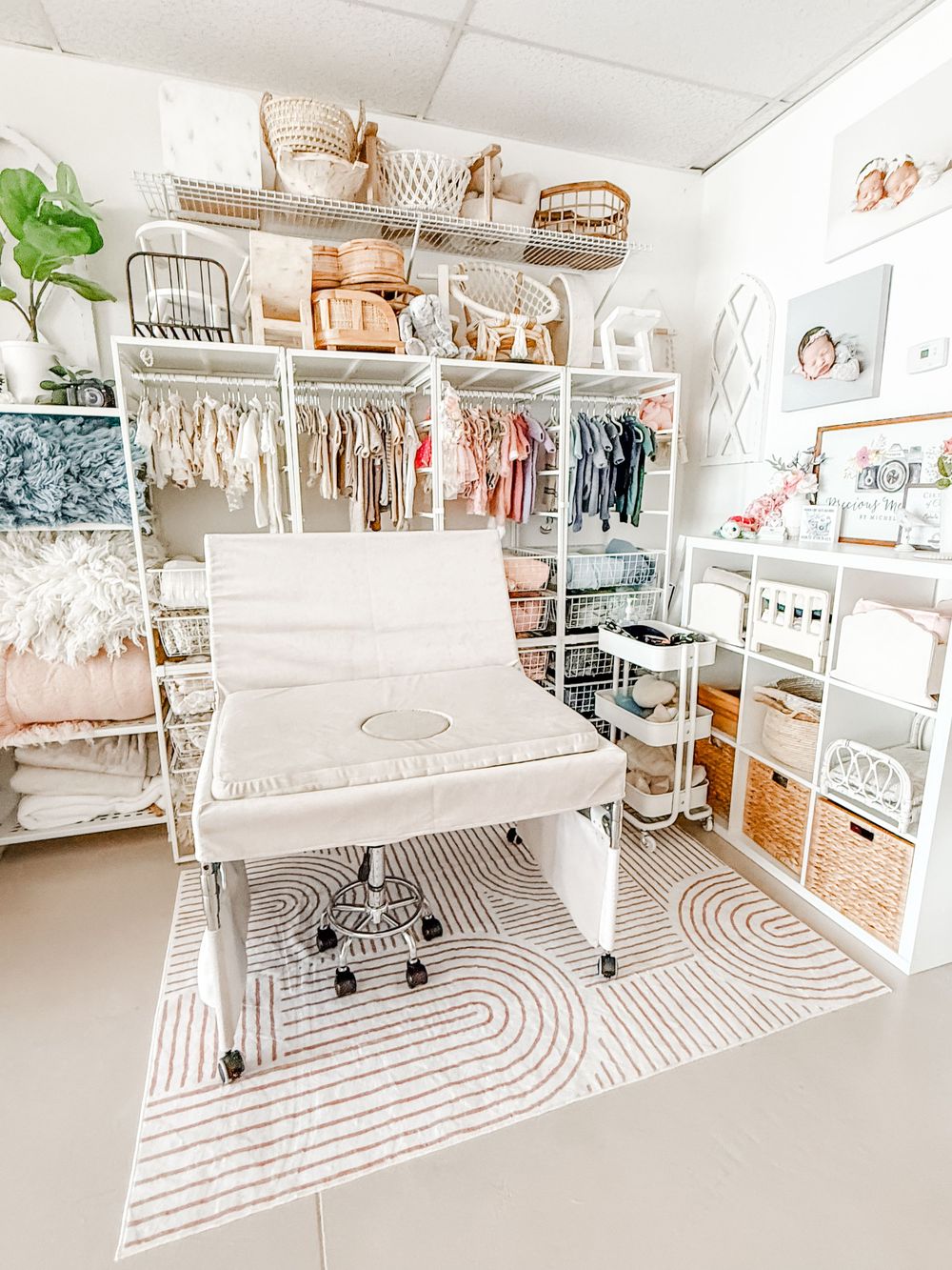 A bright white home office space with a patterned rug, organized shelving, and minimalist furniture design.