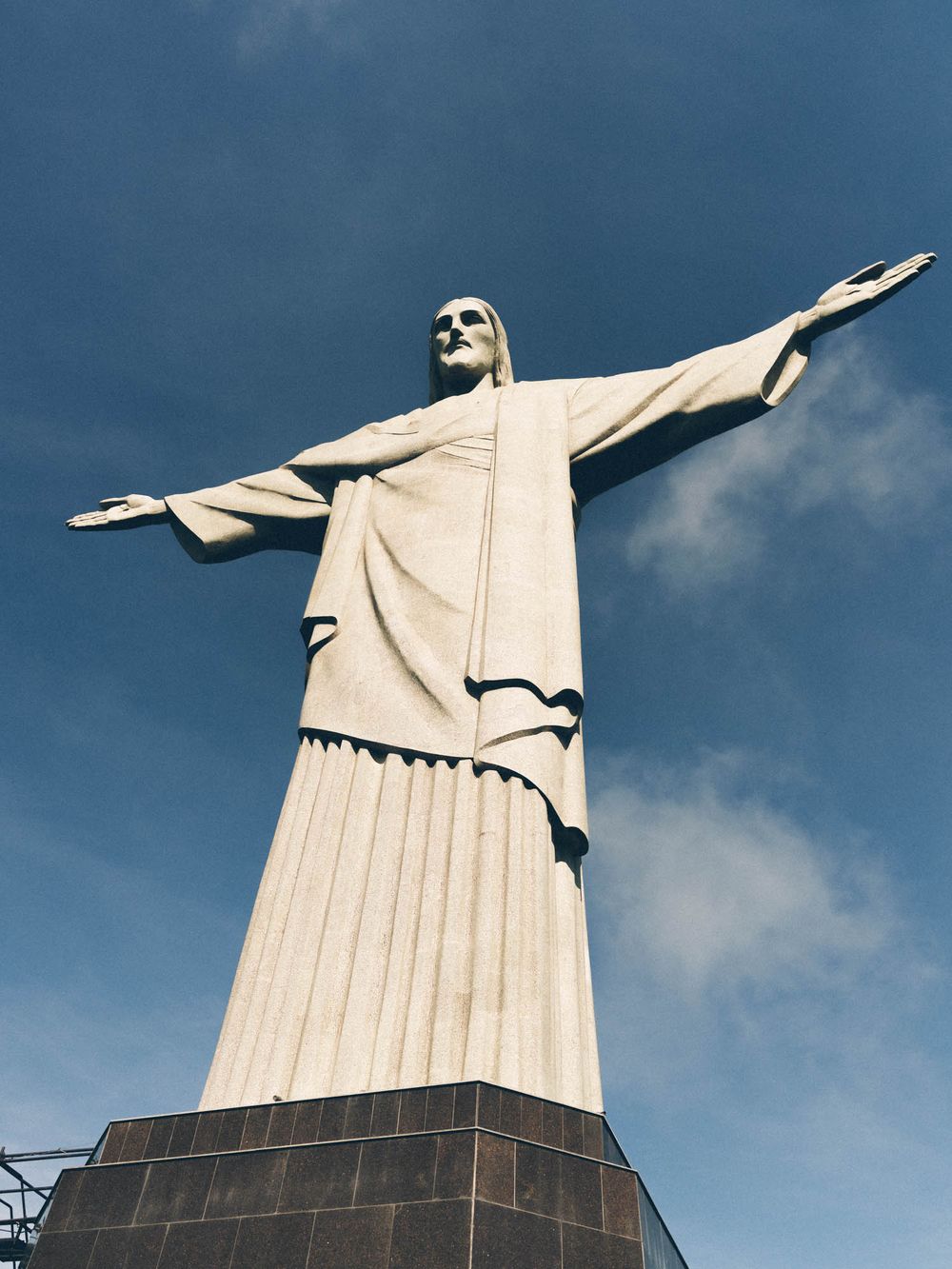 Christ the Redeemer statue in Rio de Janeiro photographed from different angles against a blue sky background.