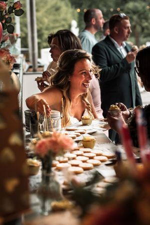 Wedding guests enjoy a festive reception dinner with table decorations and ambient lighting.