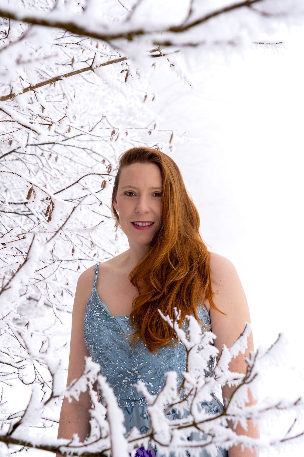 Red hair lady in the picturesque snow covered woodland in Rüti, Zürich.