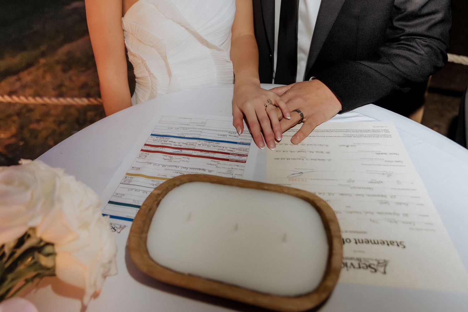 bride and groom sign marriage certificate at intimate elopement at Crooked River Distillery in New Brunswick Canada wedding photographer