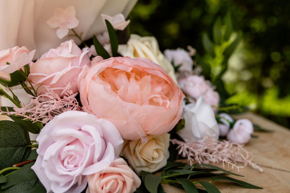 Romantic bouquet featuring pink peonies and roses with greenery.