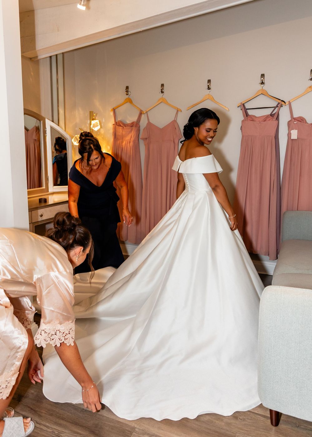 Wedding dress fitting session showing elegant white ball gown in bridal boutique.