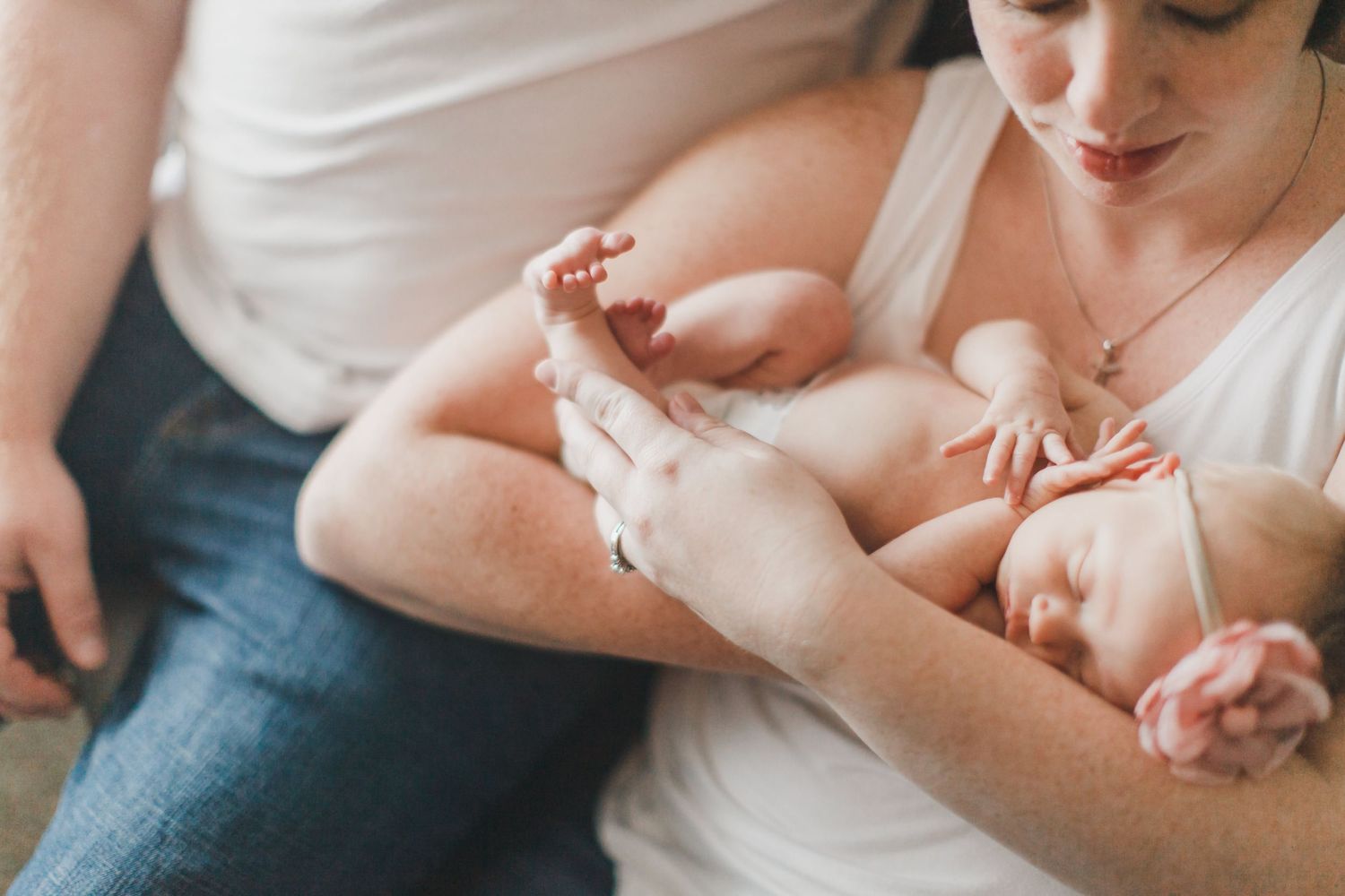 Close-up of tiny baby feet being held with care and tenderness.