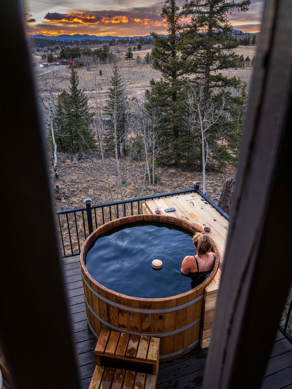 Woman soaking in a hot tub at sunset by Denver Hospitality, Travel & Tourism photographer Captain Colorado Photography.