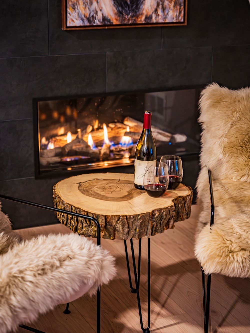Wine glasses and bottle in seating area by the fireplace by Denver Hospitality, Travel & Tourism photographer Captain Colorado Photography.