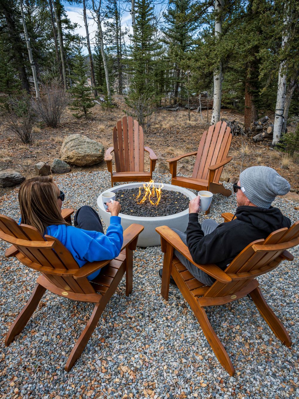 Couple sipping coffee around an outdoor firepit by Denver Hospitality, Travel & Tourism photographer Captain Colorado Photography.