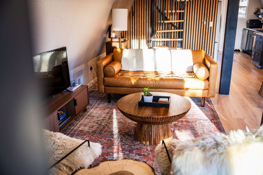 Elegant living room and spiral staircase by Denver Hospitality, Travel & Tourism photographer Captain Colorado Photography.