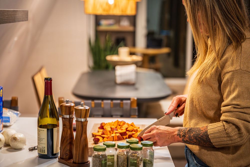 Woman preparing dinner by Denver Hospitality, Travel & Tourism photographer Captain Colorado Photography.