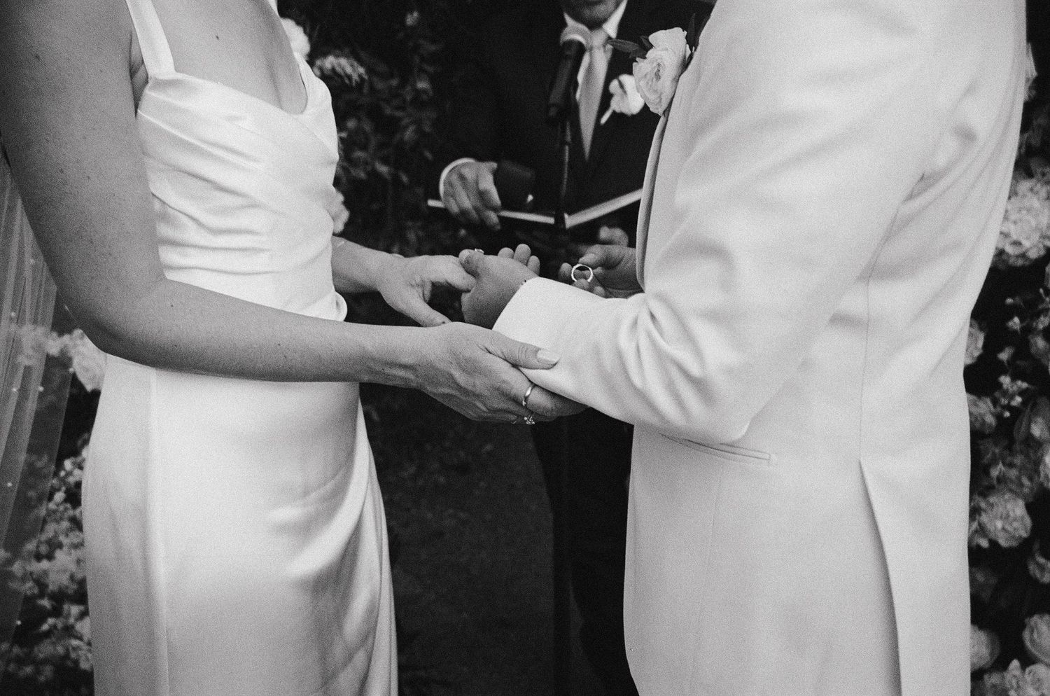 A black and white collage of wedding moments showing couples in formal attire during an elegant celebration.