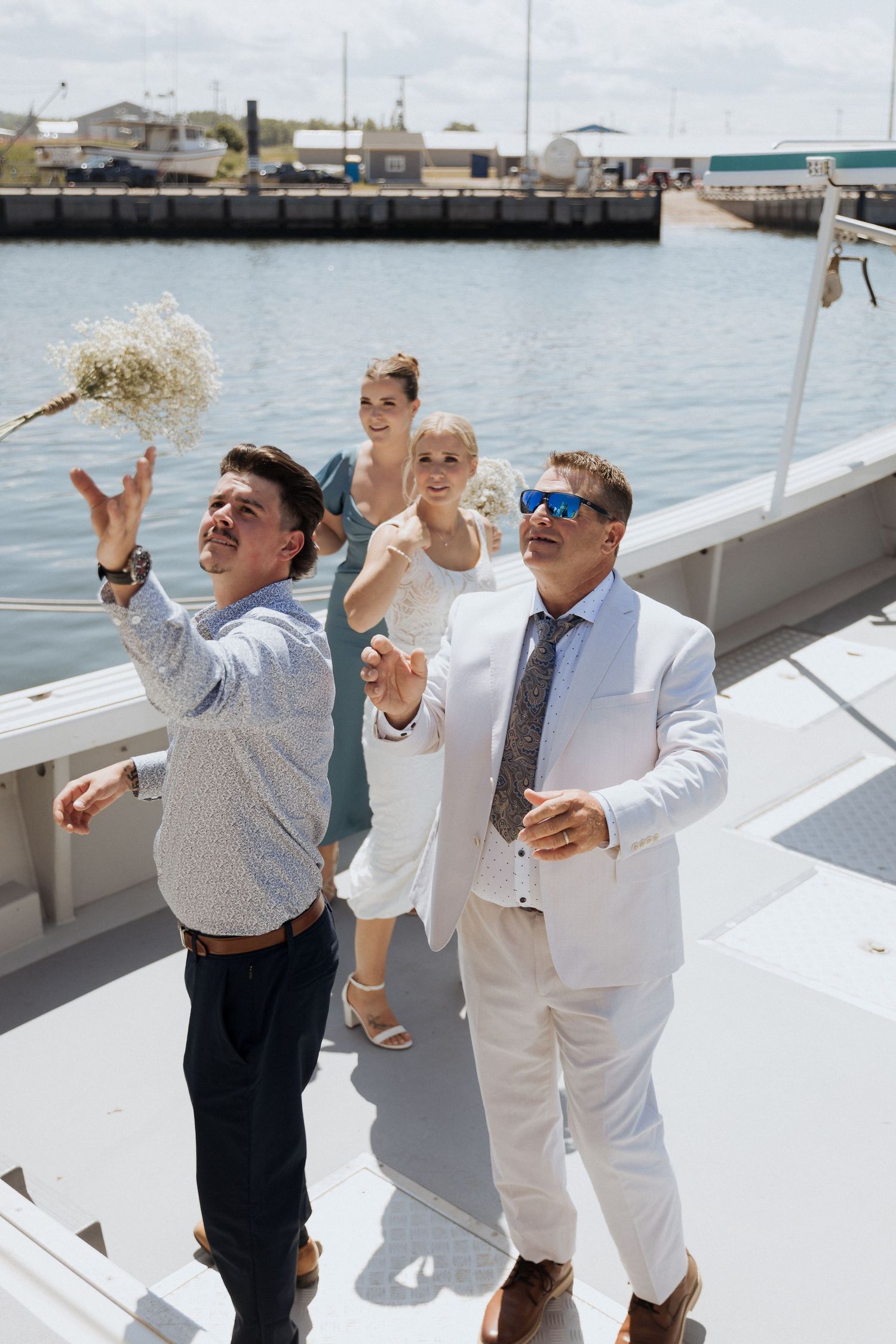 candid moment on a boat during outdoor summer wedding in Shediac New Brunswick, Moncton experienced wedding photographer, elegant portraits