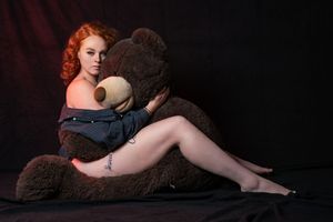 A series of artistic boudoir photos showing a figure with red hair in dramatic lighting against a dark background.