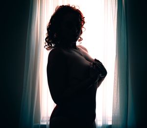 A series of silhouetted figures in dark dramatic poses against bright window light creating a moody artistic sequence.
