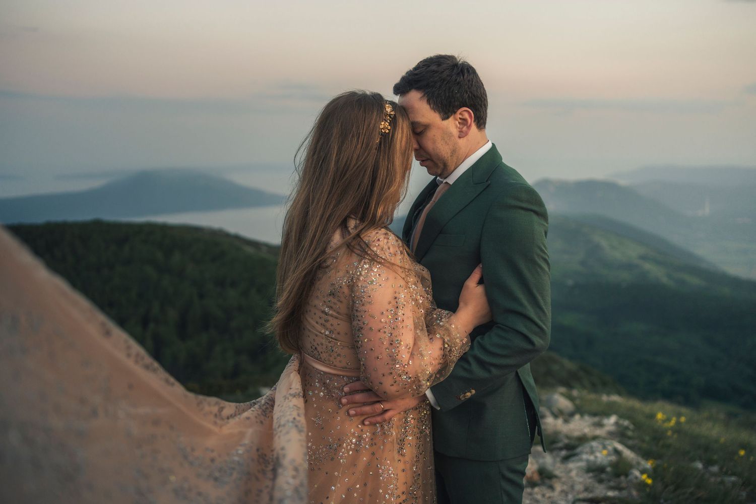 Couple kiss with sun between them