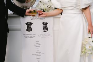 Wedding menu detail shot showing illustrated dog portraits.