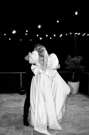 A series of nighttime photos showing figures in white on a patio with string lights overhead.