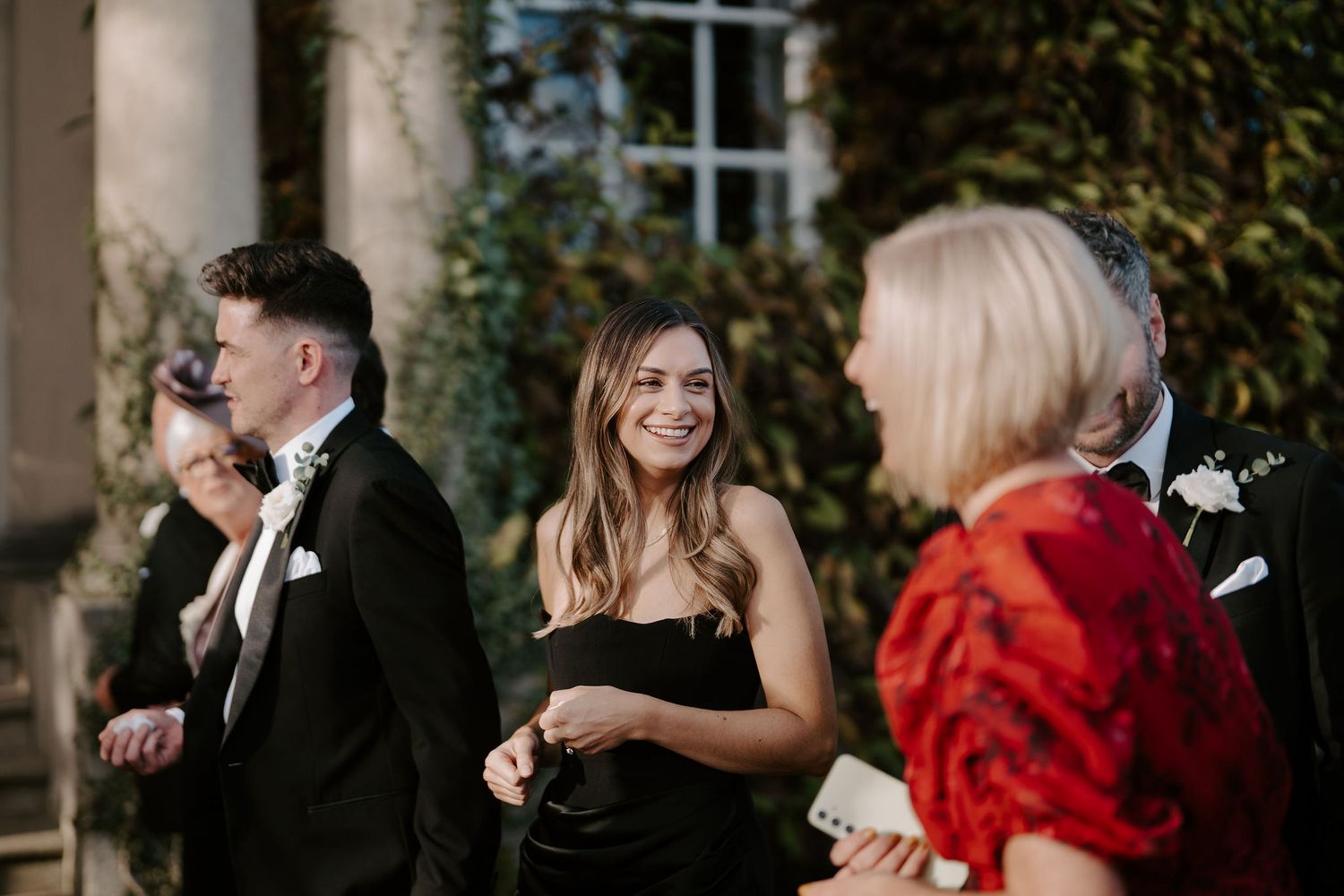 wedding guests holding confetti outside Iscoyd park