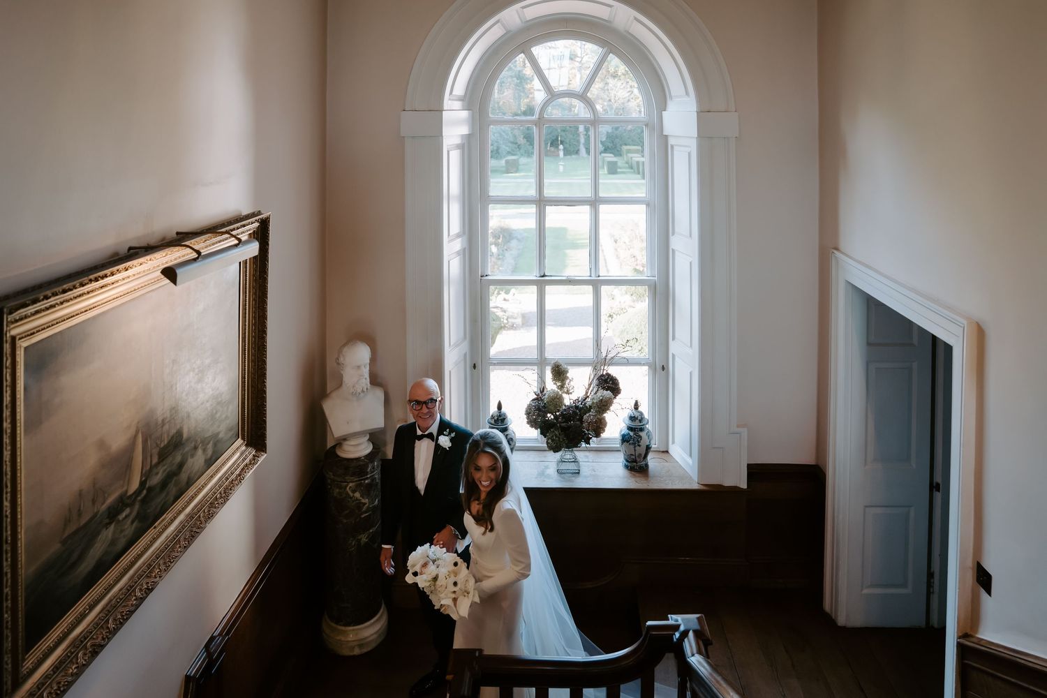 bride and dad descending stairs on their way to the ceremony at Iscoyd park