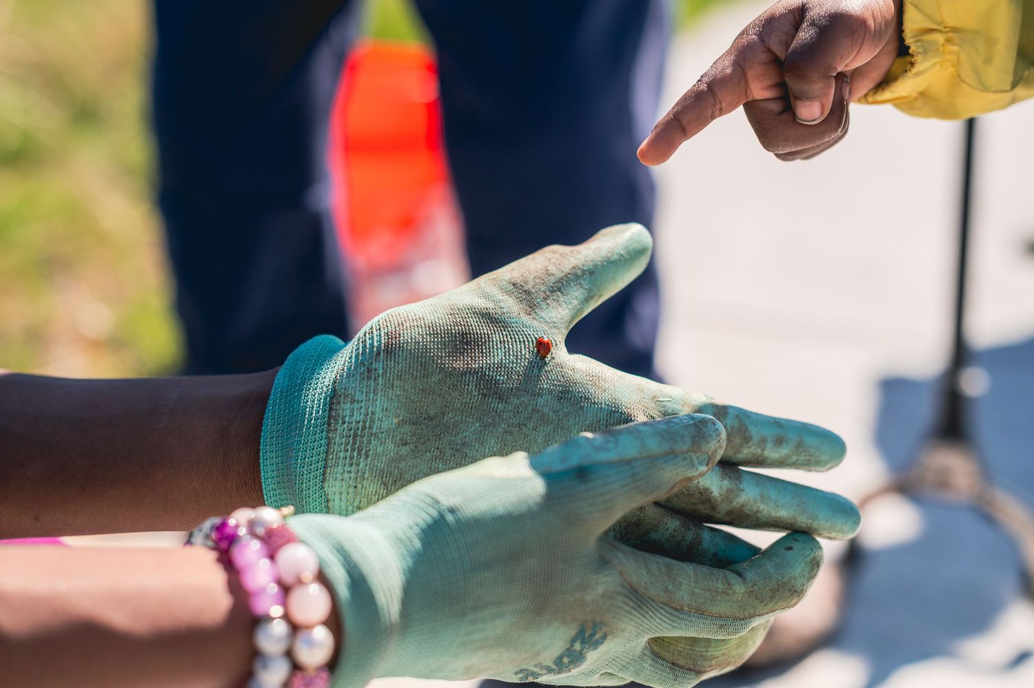 Hands wearing turquoise medical gloves demonstrate proper hand hygiene technique with soap and water.