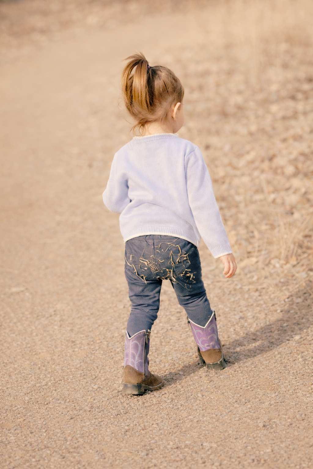 child walking down dirt path