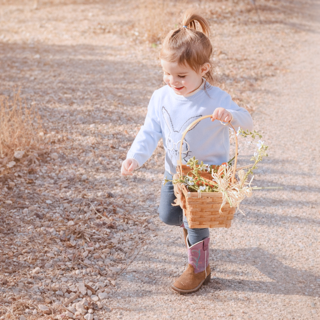 child walking on path carrying a basket