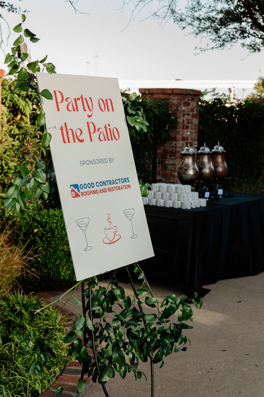Outdoor patio party sign with sponsor information and drink icons.