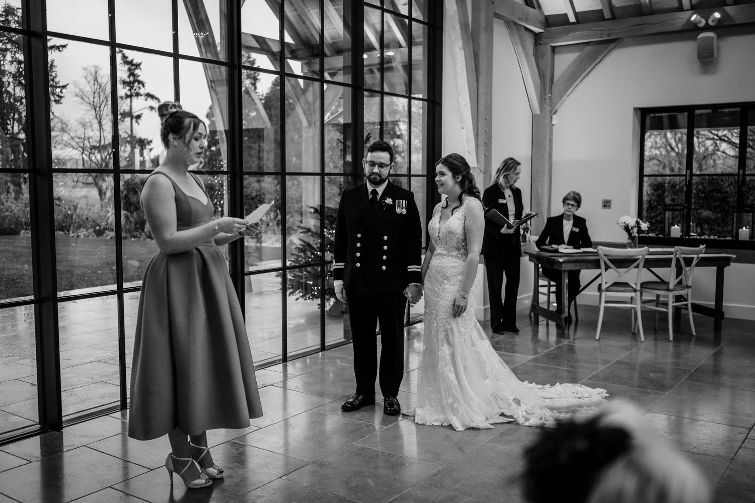 A collection of black and white wedding photographs showing moments during a ceremony and reception.