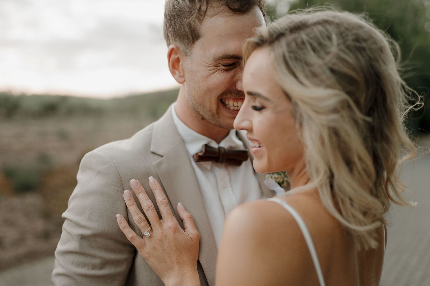 Intimate wedding portrait session captured during golden hour in natural setting.