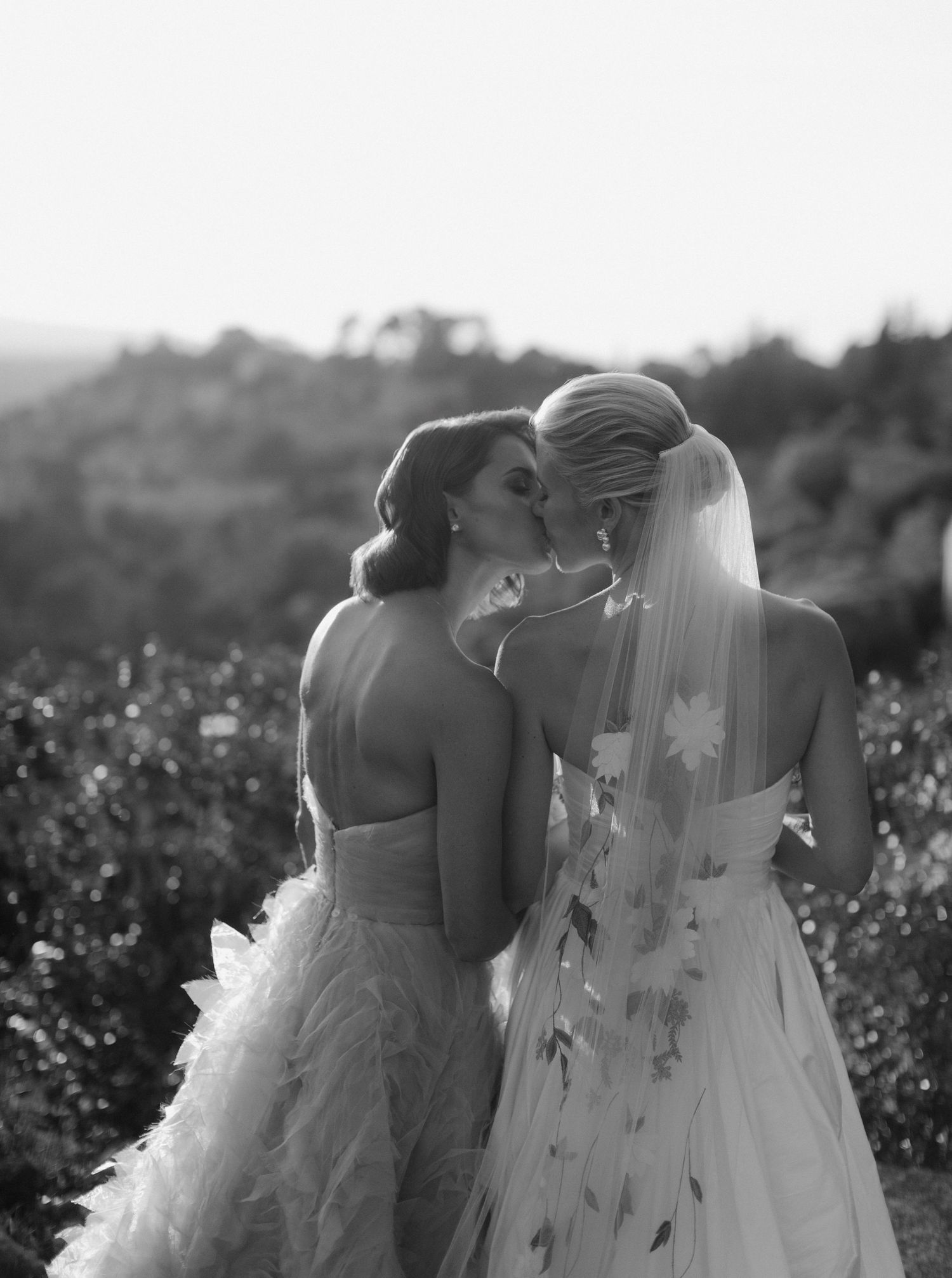 Black and white photo series showing a romantic moment between two people in wedding attire in a flower field.
