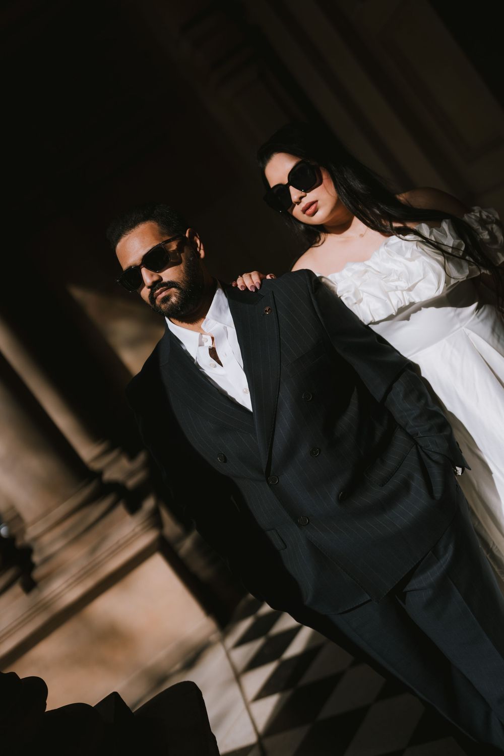 A series of artistic wedding photos showing a couple in dramatic lighting with black and white contrast.
