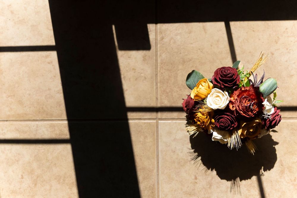 A bride's bouquet with the wedding band and ring on top.