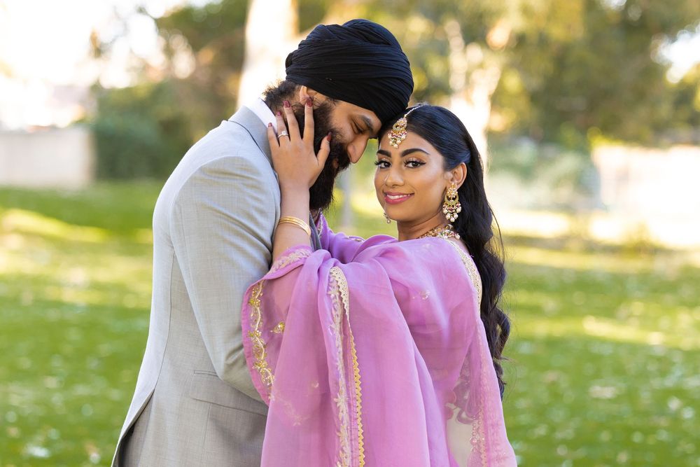 A bride and groom dressed in traditional indian wedding attire for their wedding day.