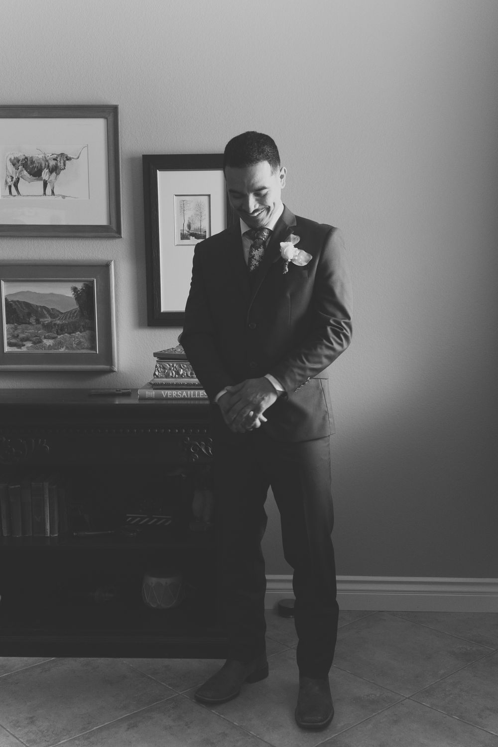 A groom adjusting his cuff links on his wedding day.