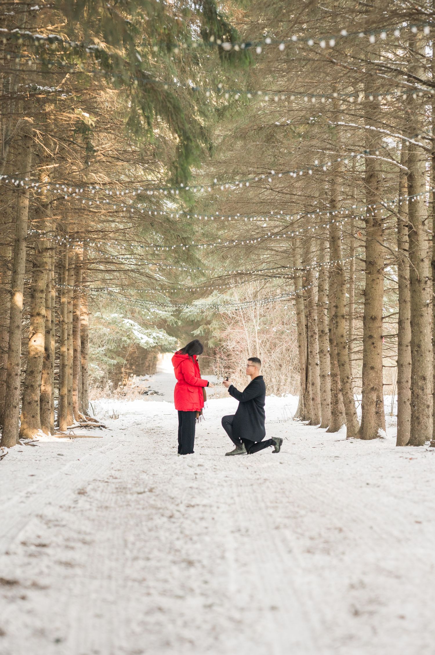A couple shares a romantic moment in a rustic wooden hallway with vintage decor and warm lighting.