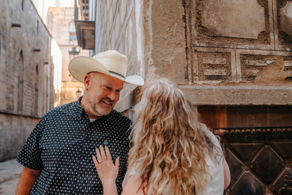 Romantic portrait of couple under the Pont del Bisbe bridge.